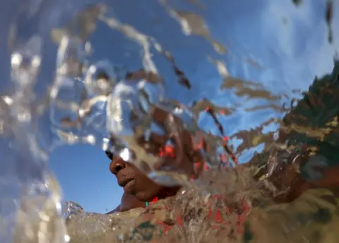 Zohra Bensemra / Reuters Khadjou Sambe surfs in the ocean