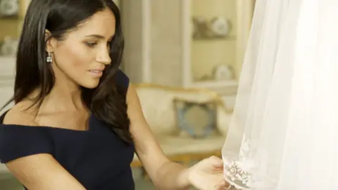 Oxford Films/ITV Duchess of Sussex examines the embroidery on her wedding dress