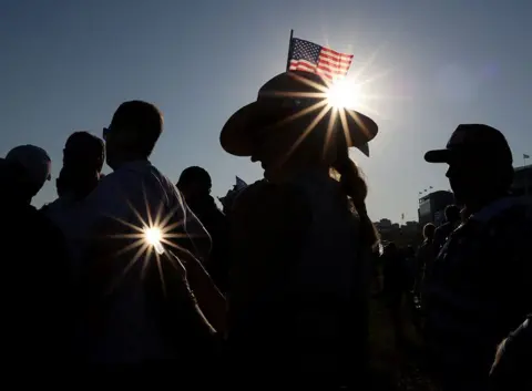 Yara Nardi / Reuters A fan carries a US flag in their hat on a golf course
