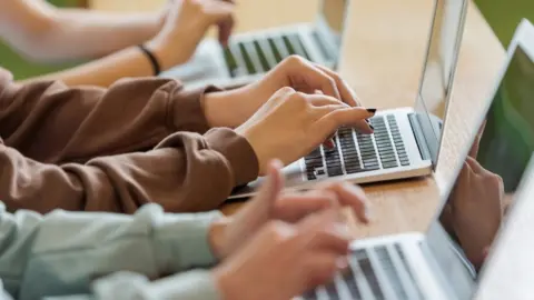 Getty Images Teenagers using laptops