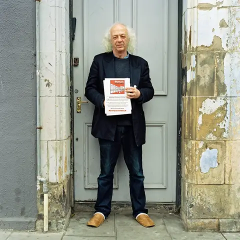 Ilya Ilford Man holding posters in Leith