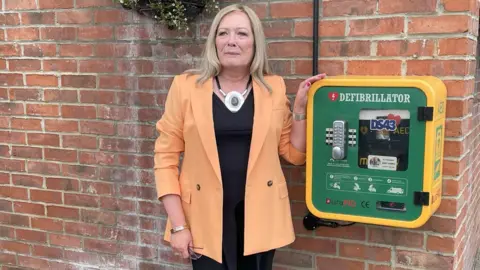 BHF Pam Shurmer with an accessible defibrillator