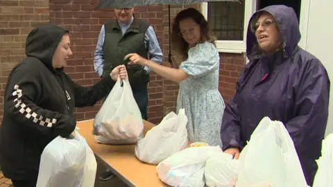 BBC People queuing at a mobile food club in Wythenshawe