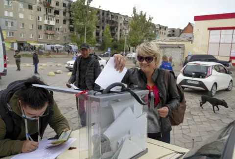 Getty Images People cast their votes in Russia's so-called referendum in Mariupol, Donetsk - 26 September 2022