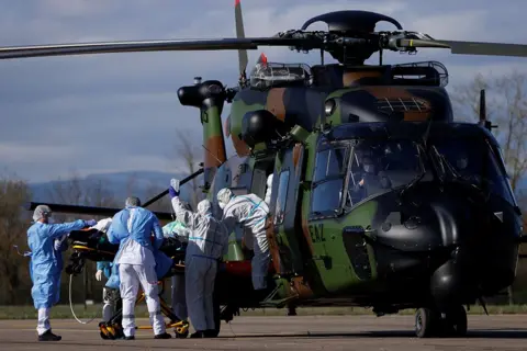 Christian Hartmann / Reuters A patient being loaded into a helicopter