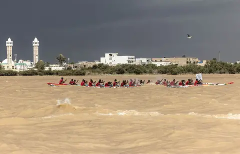 John Wessels / AFP A pirogue team races along the Senegal River in Saint-Louis, Senegal, on 23 July 2022