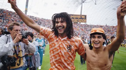 Getty Images Netherlands players Ruud Gullit (left) and Gerald Vanenburg celebrate after their 2-0 victory in the 1988 European Championships final