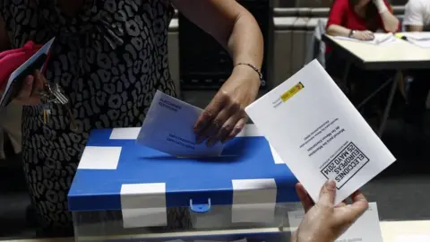 Getty Images A woman casts her vote in Spain in 2014