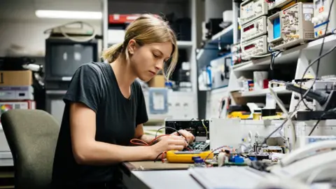 Getty Images Woman working on an electrical circuit board