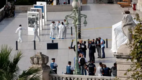 Reuters Police investigators work outside the Saint Charles train station after French soldiers shot and killed a man who stabbed two women to death at the main train station in Marseille, France (October 1, 2017)