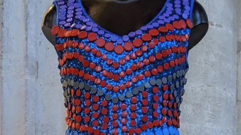 Peterborough Cathedral Part of a dress made from vaccine lids