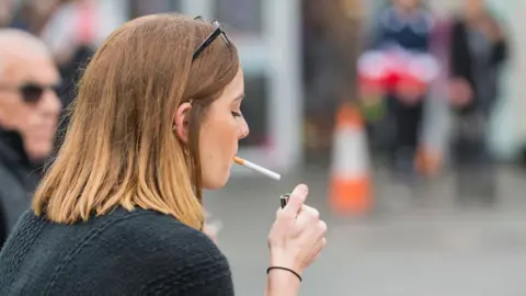 Alamy Young woman smoking