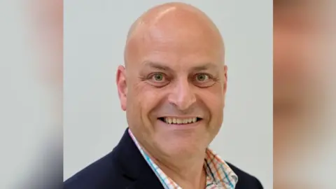 Slough Borough Council Slough Borough Council's profile picture of Robert Stedmond, who is bald and is wearing a patterned shirt and dark jacket.