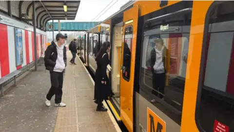 The new Tyne and Wear Metro train on its first journey through Sunderland, pictured at the Stadium of Light with people alighting the train.