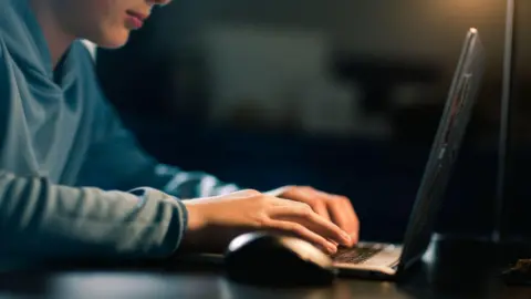 Getty Images Teenage boy using computer