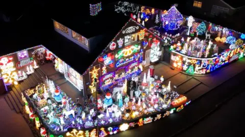 A house covered in thousands of Christmas lights.