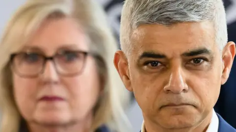 Getty Images A close up of the Sir Sadiq Khan in the foreground, with Susan Hall out of focus behind him.