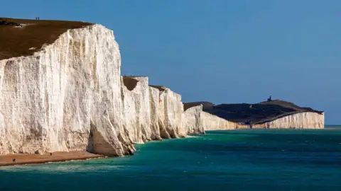 Getty Images The white cliffs of the Seven Sisters, overlooking a deep turquoise sea.