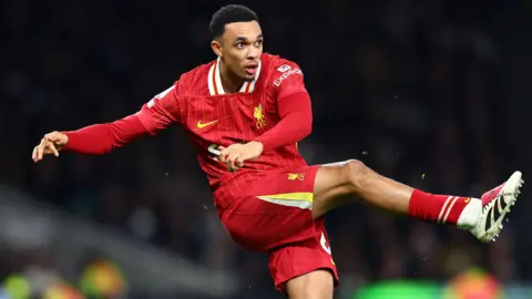 Liverpool's Trent Alexander-Arnold kicks the ball with his right foot in the Premier League game against Tottenham