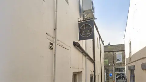 Google Side view of The Beer Engine on Albert Terrace in Skipton with the pub sign hanging above a doorway.