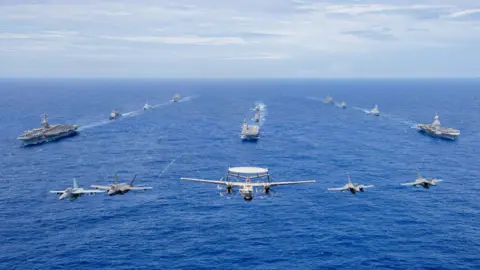 BBC/Natalie Thomas The USS Carl Vinson, left, JS Kaga, centre, and FS Charles de Gaulle, right, taking part in joint exercise Pacific Stellar