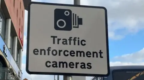 Close-up of sign reading "traffic enforcement cameras"