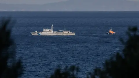 Reuters A Greek Coast Guard ship and an escorting vessel take part in a search and rescue operation following a shipwreck, where at least eight migrants drown off the island of Samos, Greece.