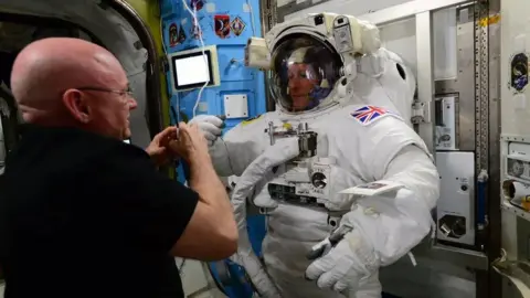 ESA Tim Peak wearing an astonaut outfit with helmet