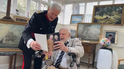 BBC Lt Willis being presented with his card