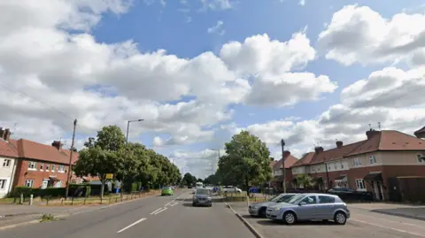 Road with a cloudy sky above
