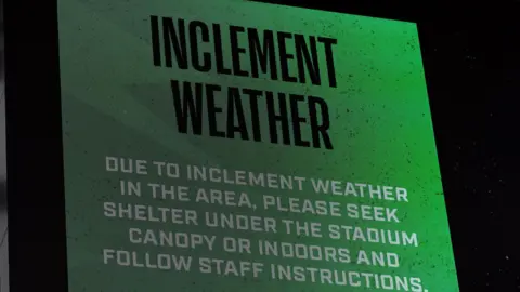 A message at the Q2 Stadium in Texas tells fans to seek shelter because of extreme weather