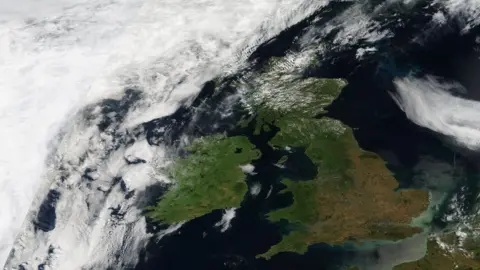 NASA A satellite image of the UK, with much of southern England and the Midlands looking brown and parched.