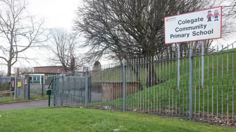 LDRS The outside of Colegate School surrounded by metal fencing and fields.