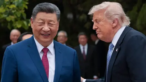US President Donald Trump (R) speaks with China's President Xi Jinping as he leaves after a visit to Zhongnanhai Garden in Beijing on May 15, 2026. 