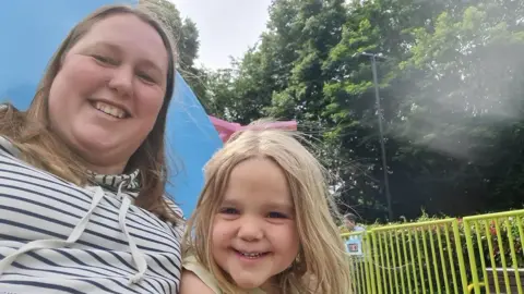 Supplied A selfie-style image of Nikki Graham with her young daughter - who has blonde hair.