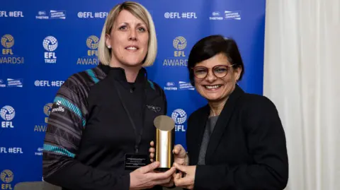 Robins Foundation Jade Bailey (left) holding a gold award with Bristol MP Thangam Debbonaire. 