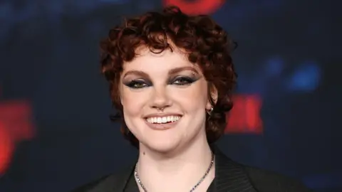 Getty Images Shannon Purser, with short, red curly hair and dark makeup.