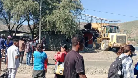 Bulldozers taking down houses