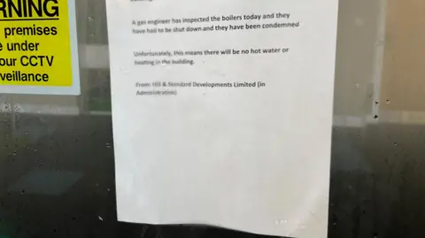 A letter saying that a building will be shut as there is no hot water or gas