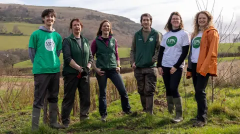 NPK Recovery Staff from NPK Recovery and Stump up for Trees pose for a photograph at a tree nursery near Abergavenny