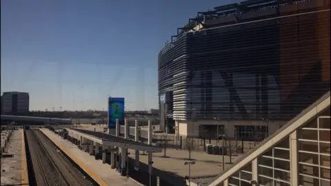The Meadowlands New Jersey Transit station with the MetLife Stadium in the background.