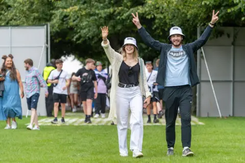 Getty Images Man and woman arrive at Glasgow Green for TRNSMT festival