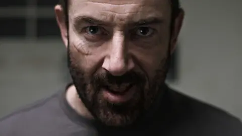 Jailbroken Films An angry looking man stares at the camera