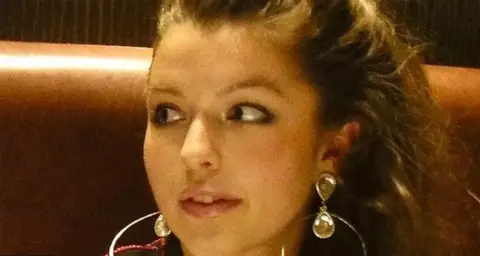 Groves family A close-up of Sarah who has brown hair and big earrings