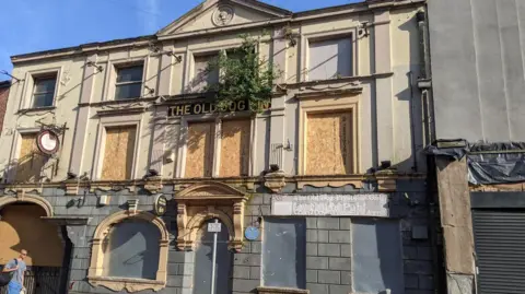 External view of the derelict listed building which was the Old Dog Inn pub until 2018.  