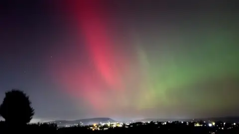 Simon Ricketts Red and green Northern Lights over Pendle Hill