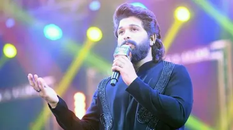 Getty Images Telugu film actor Allu Arjun seen on stage wearing an embroidered black suit during the launch of the trailer for his film 'Pushpa 2', at Gandhi Maidan on November 17, 2024 in Patna