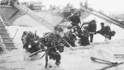 Getty Images Troops from the 48th Royal Marines at Saint-Aubin-sur-mer on Juno Beach, Normandy, France, during the D-Day landings, 6th June 1944