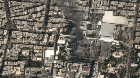 BBC A satellite image shows black smoke rising above Iranian Supreme Leader Ayatollah Ali Khamenei's compound.