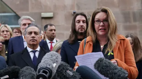 PA Media Bereaved families of the Nottingham attacks standing outside Nottingham Crown Court after Valdo Calocane was sentenced in January 2024. 
